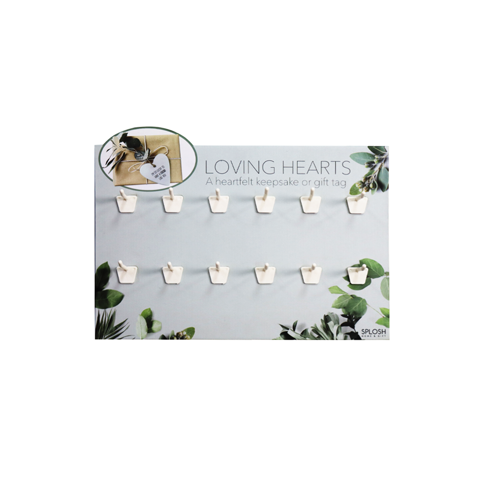 Front view of a cardboard gift tag display with twelve white peg hooks