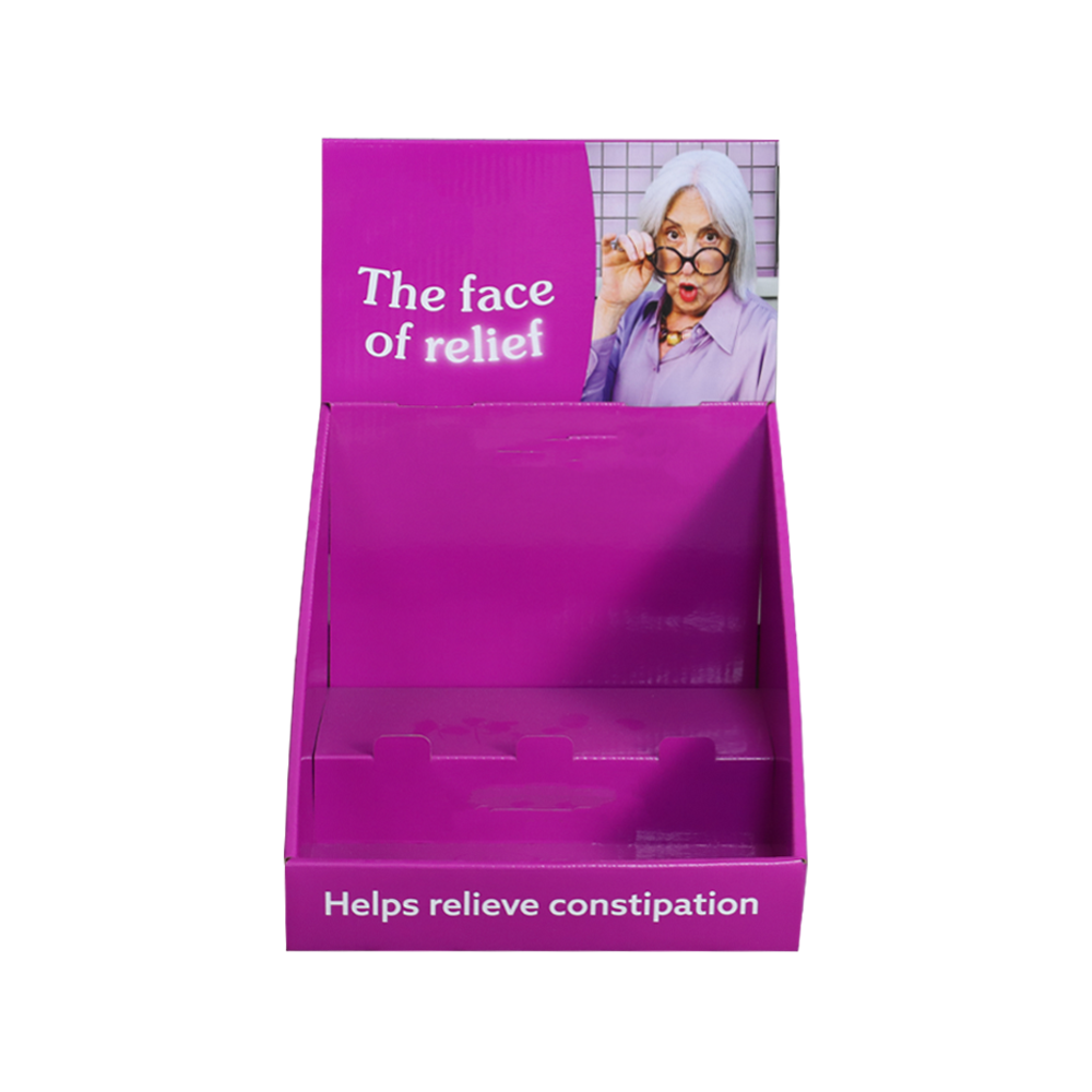 Front view of a purple medicine PDQ display box with an open tray and printed promotional header
