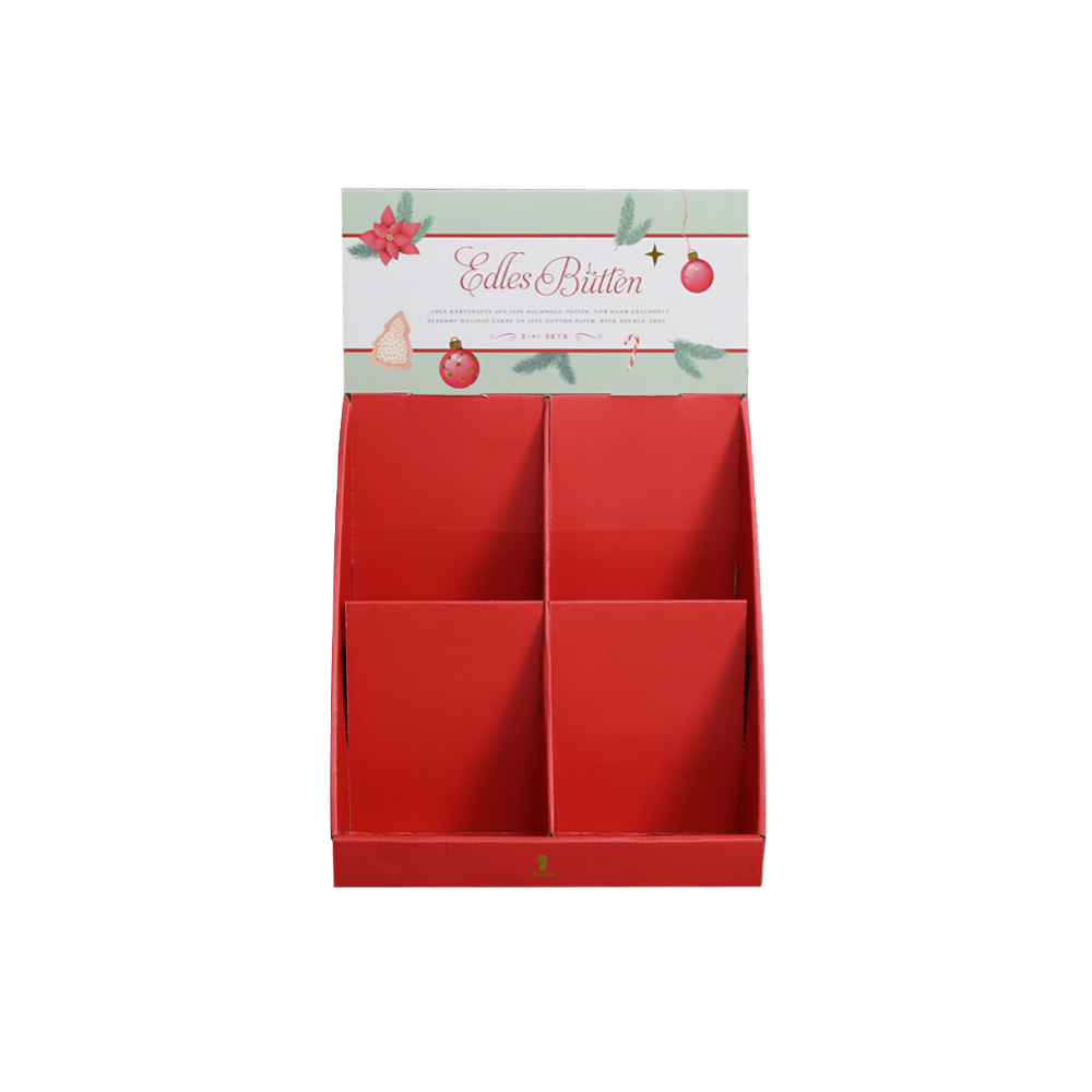 Front view of a red Christmas cardboard PDQ display with four angled compartments